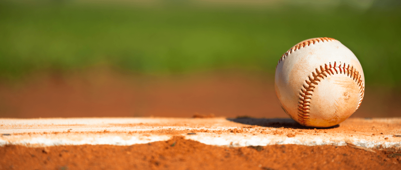 A baseball on a pitcher's mound. Practicing the right mechanics can prevent pitching injuries.